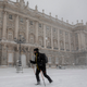 People walk on the snow next to the Royal Palace during heavy snowfall on January 09, 2021 in Madrid, Spain.